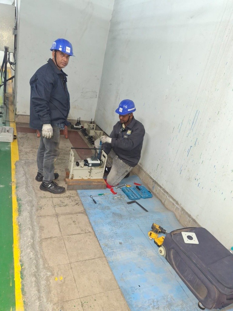 Technicians performing panel maintenance